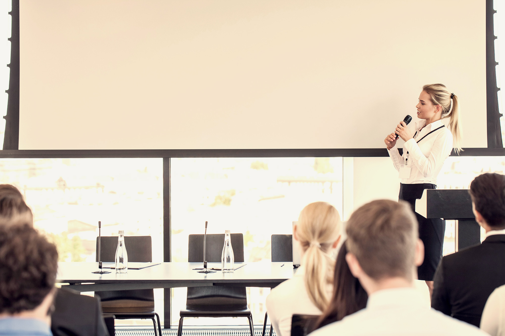 woman speaking in front of group