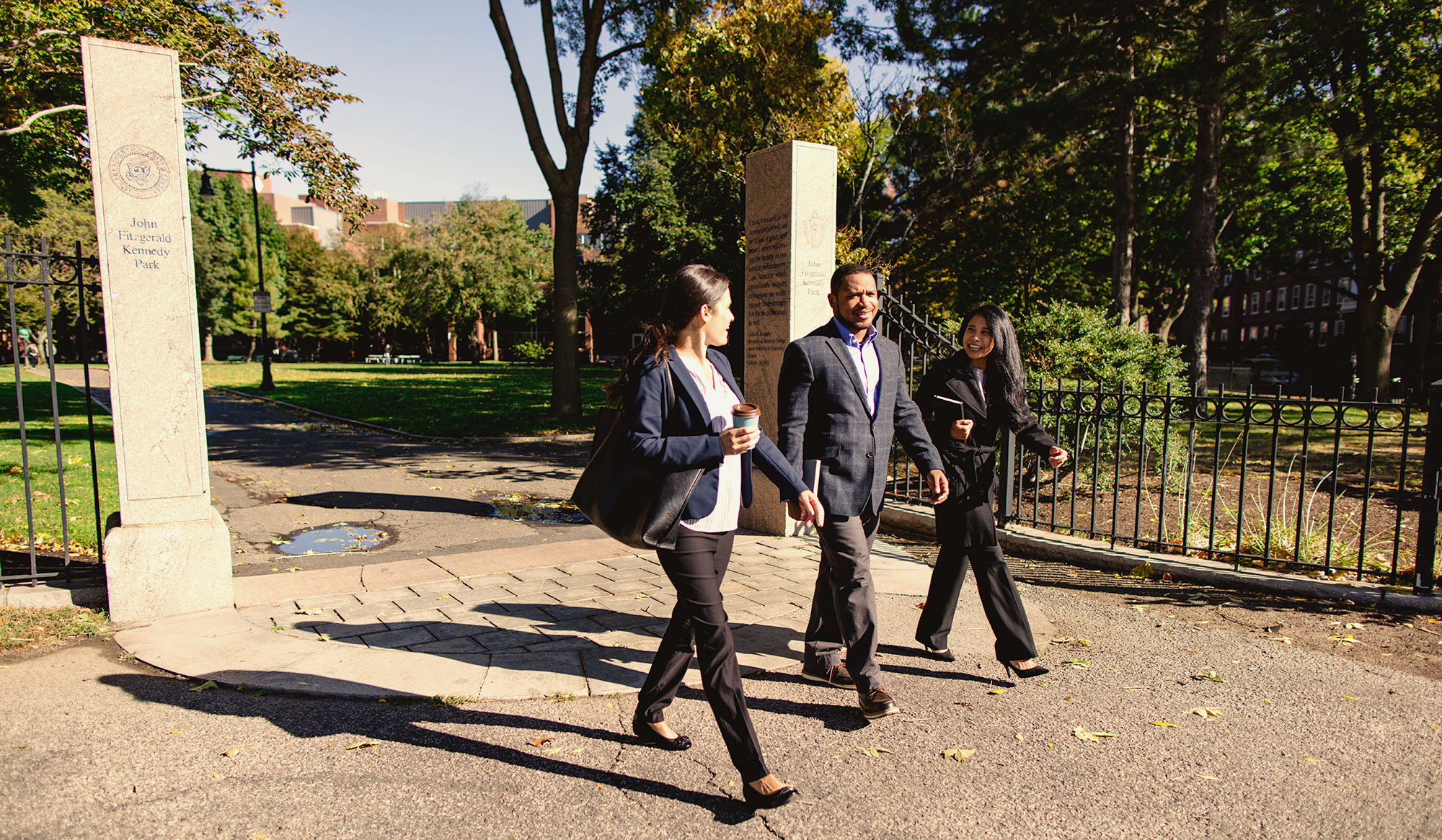 three colleagues walking outside talking