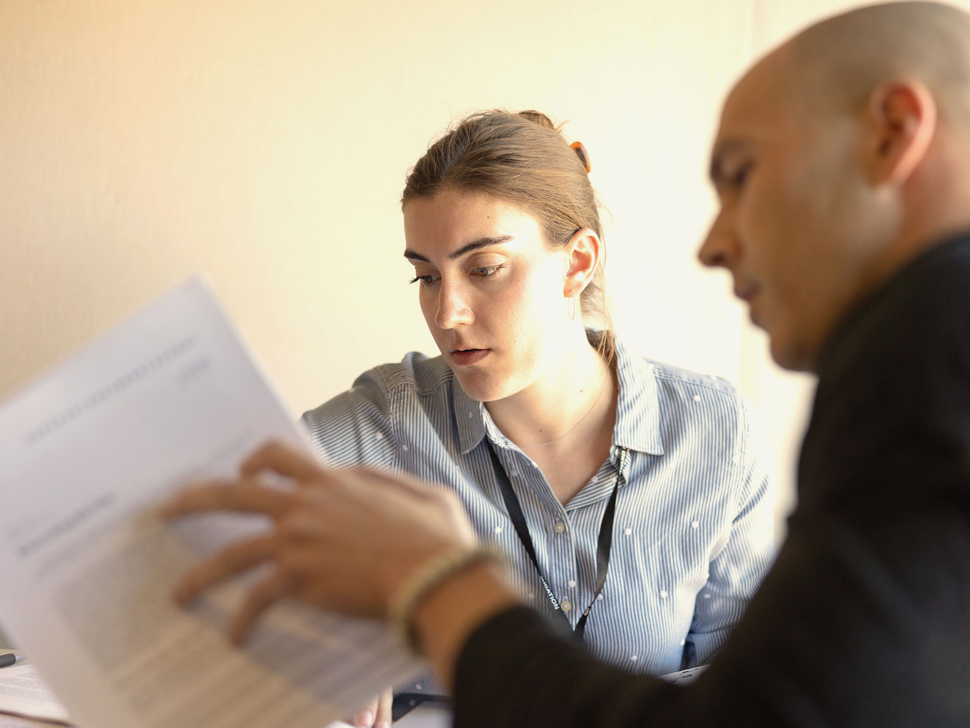 A man and woman look over printed documents together.